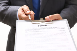 Handsome man in suit offer contract form on clipboard pad